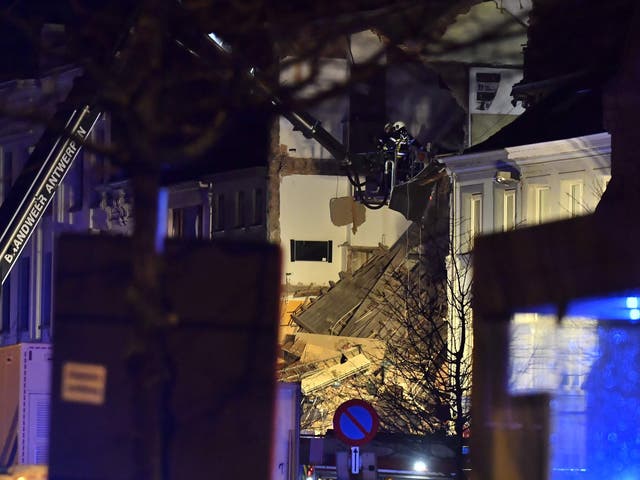 Firefighters inspect a collapsed building, at the Paardenmarkt in Atnwerp after several properties were damaged in an explosion
