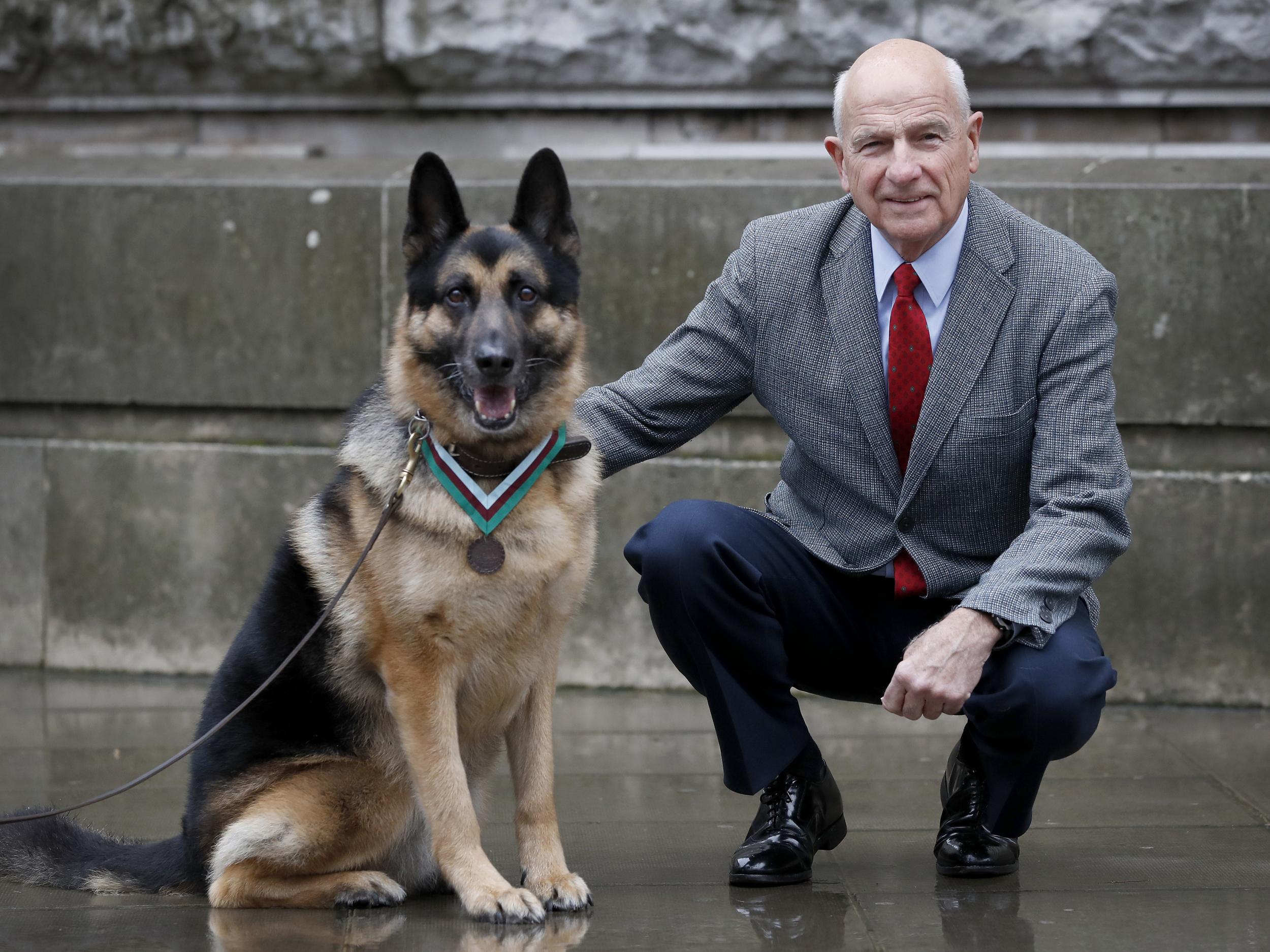 John Wren from New York - who was four years old when Chips, the family pet dog, returned from the war effort - with Military working dog Ayron who received the PDSA Dickin Medal, the animal equivalent of the Victoria Cross, on Chips' behalf in London