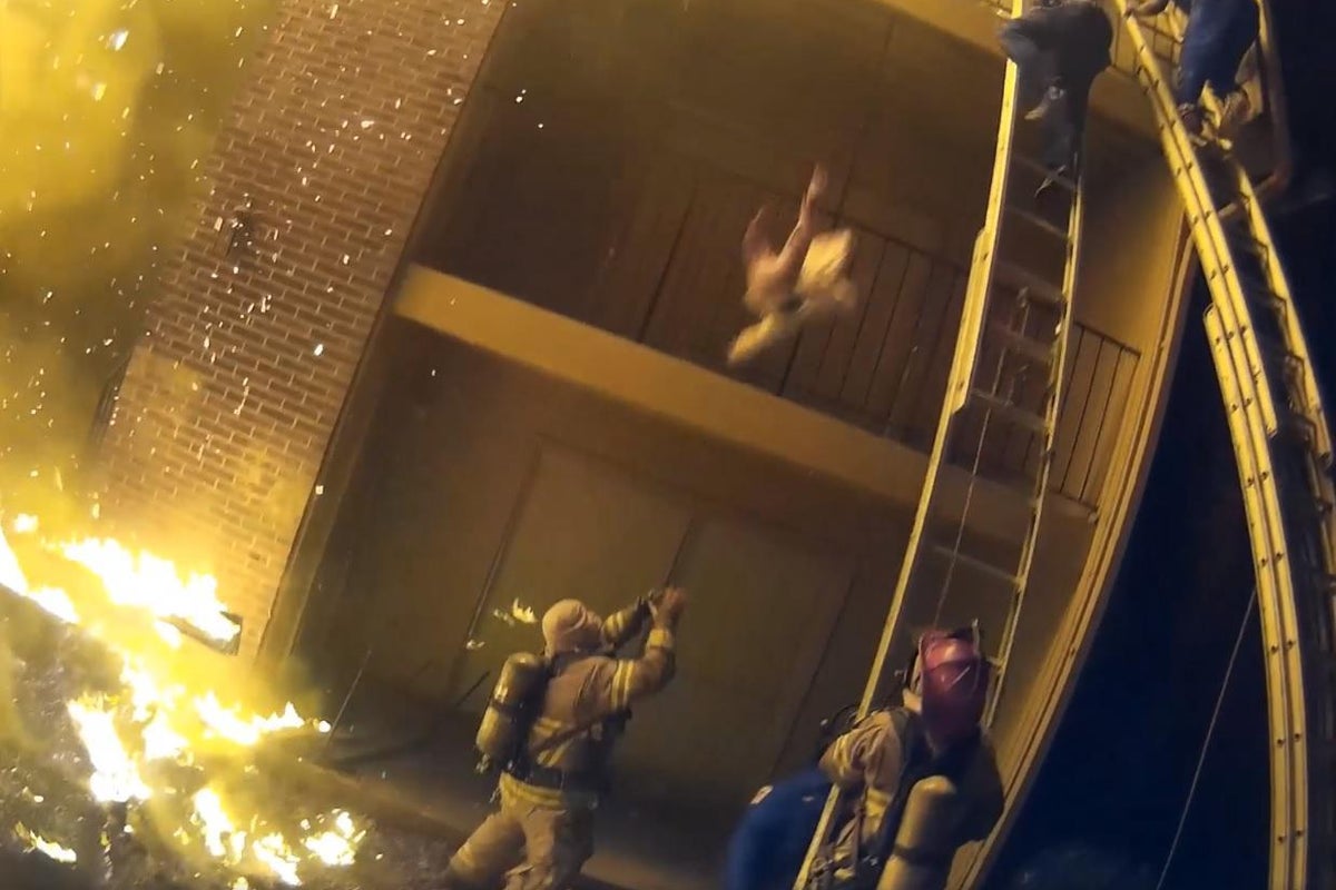 Firefighter catches child thrown from burning building | The ...