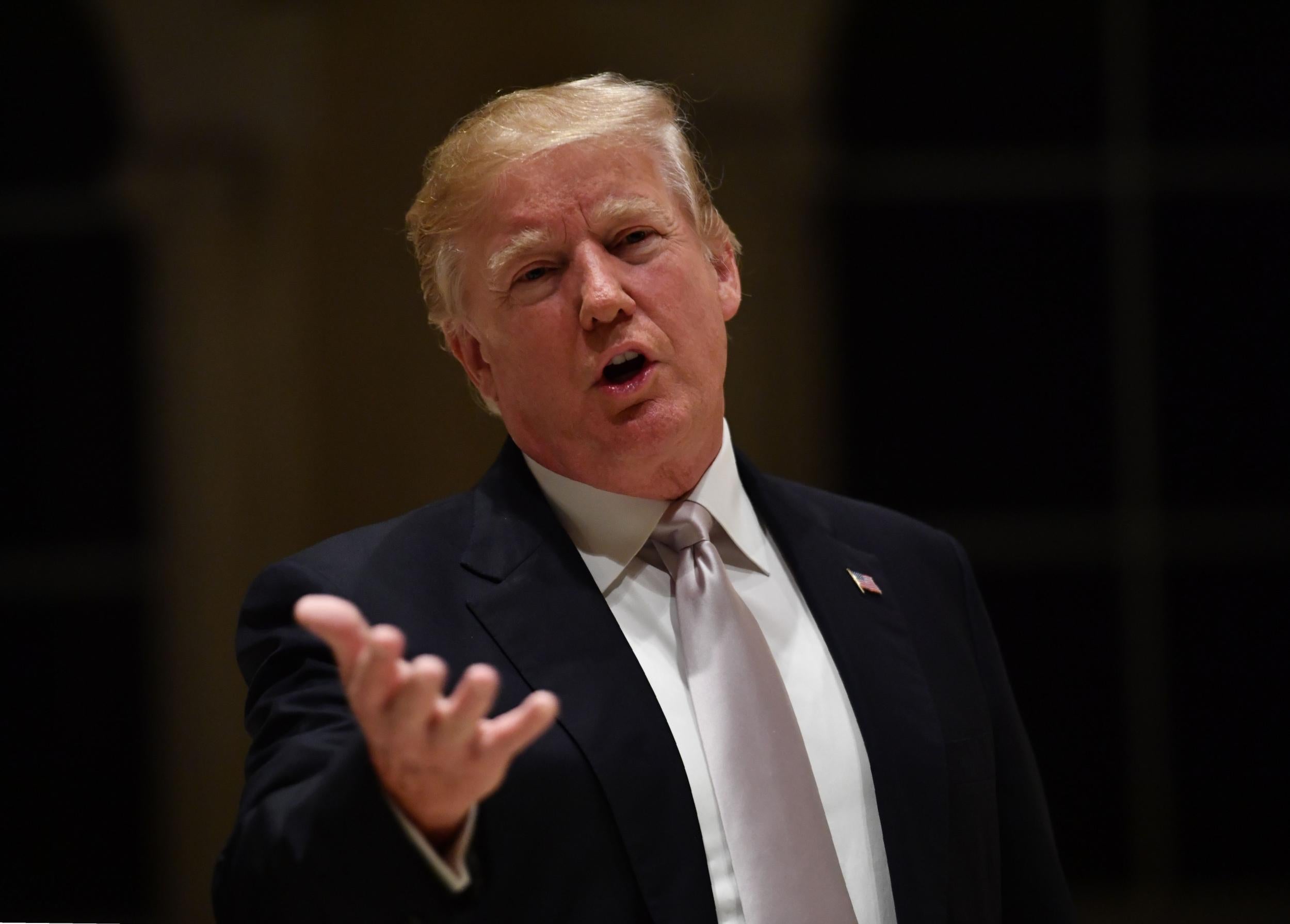 US President Donald Trump speaks to reporters at Trump International Golf Club in West Palm Beach