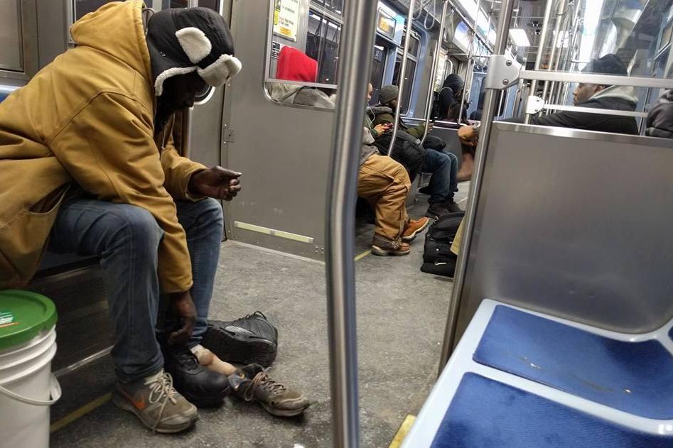 Passenger photographs the moment stranger gave homeless man the shoes off his own feet on Chicago train The Independent The Independent image