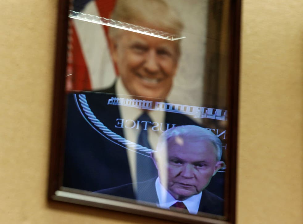 Video image Jeff Sessions is reflected in a picture of Donald Trump