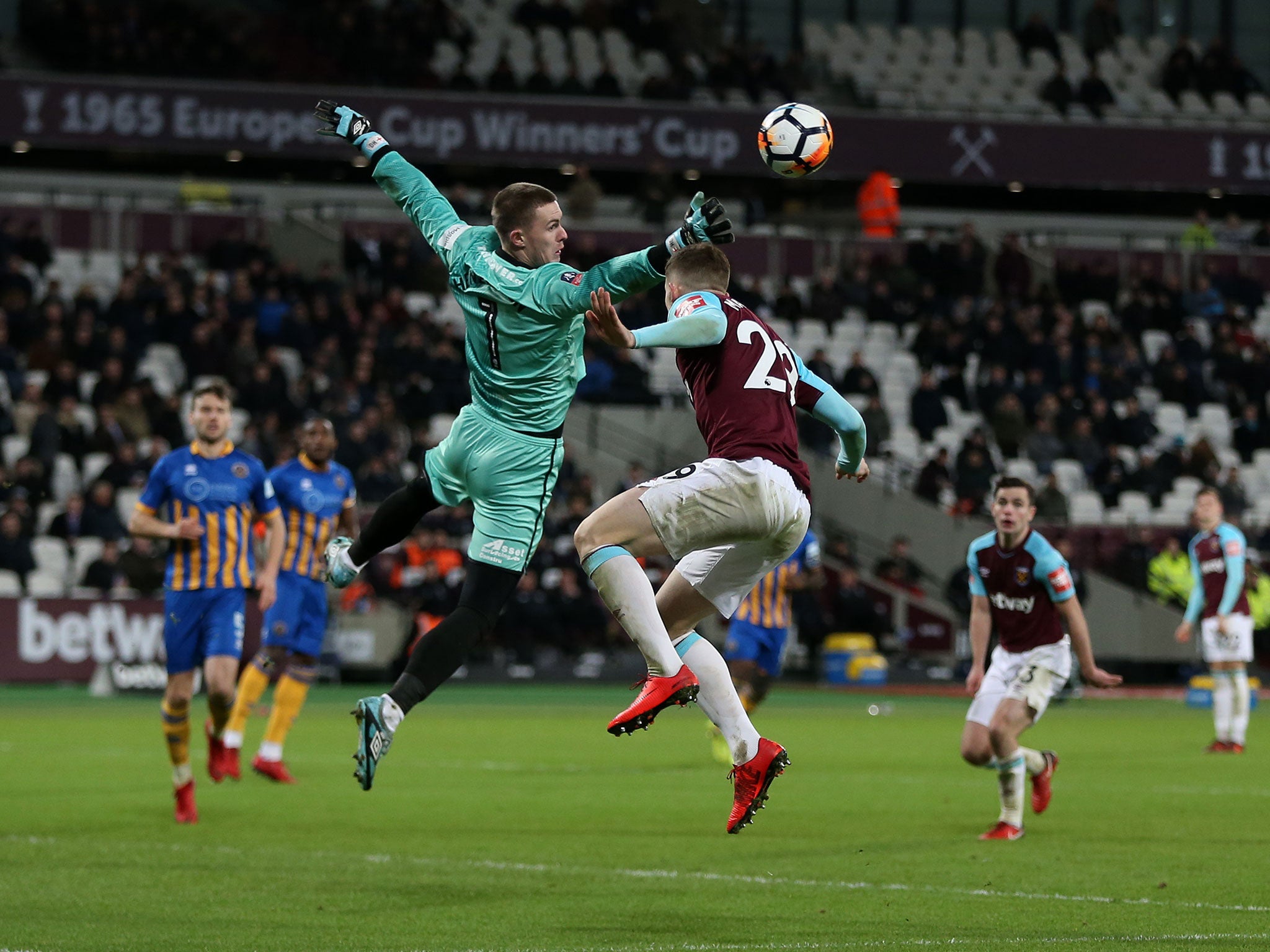 Dean Henderson punches clear a dangerous West Ham delivery