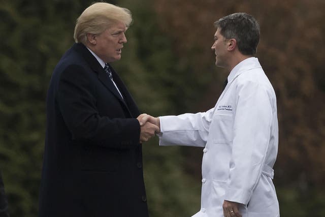 US President Donald Trump shakes hands with White House Physician Rear Admiral Dr. Ronny Jackson