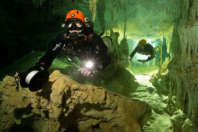 A scuba diver measures the length of Sac Actun underwater cave system as part of the Gran Acuifero Maya Project near Tulum, in Quintana Roo state, Mexico