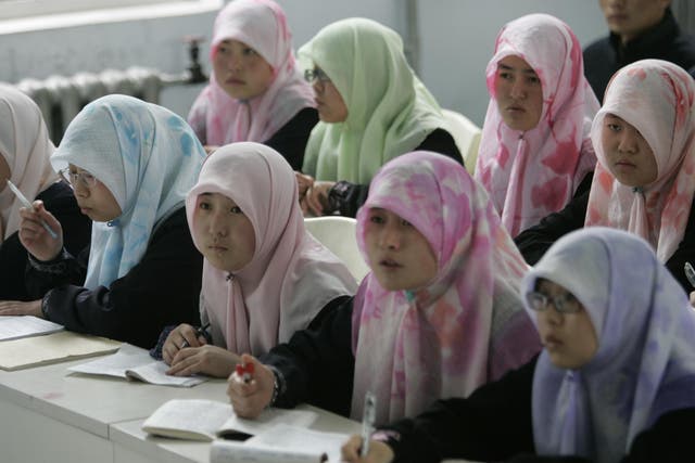 Muslim students from the Chinese Hui minority study in a class at Ningxia Islamic College in Yinchuan