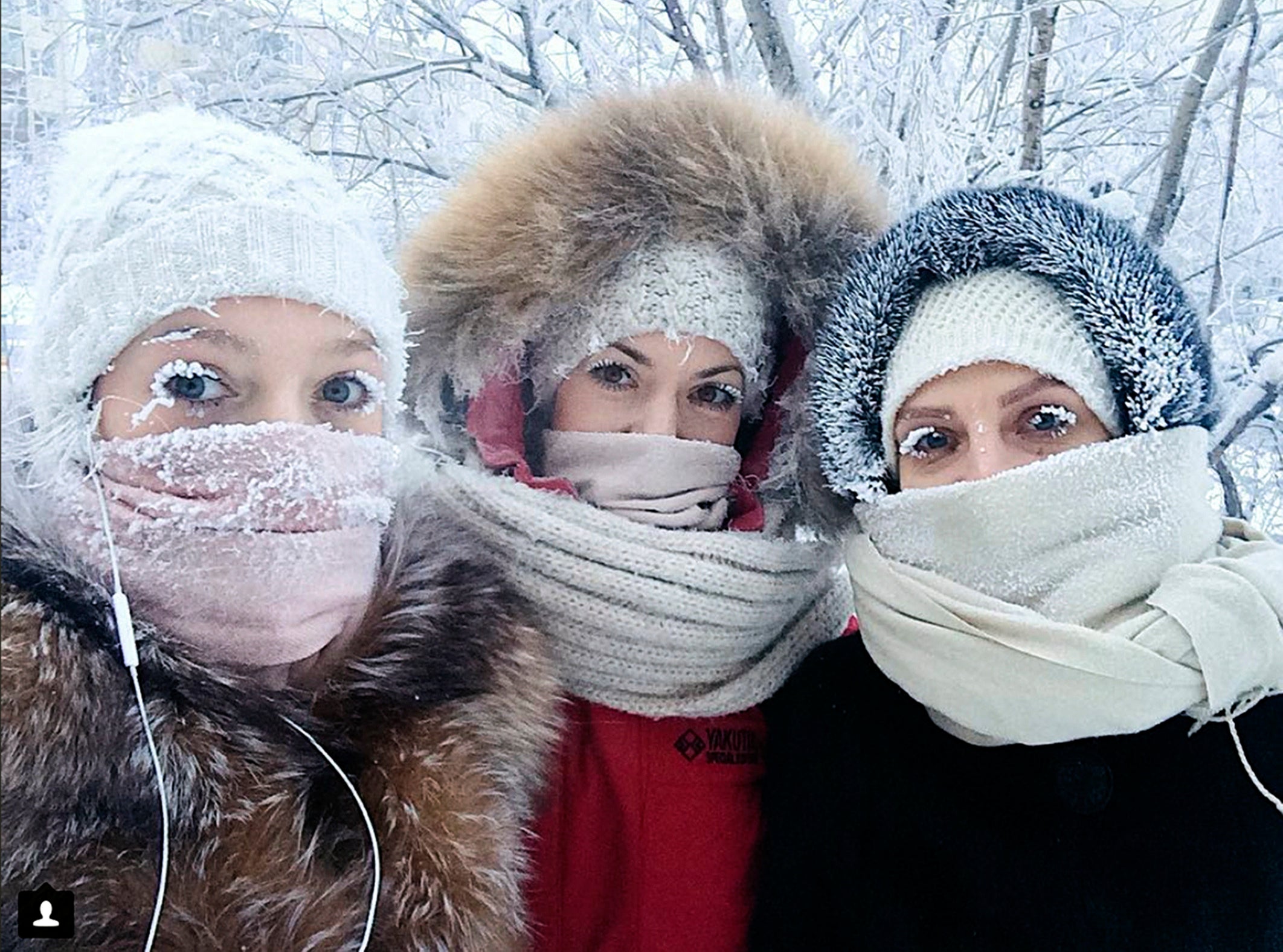 Anastasia Gruzdeva, left, poses for selfie with her friends as the temperature dropped below -50 degrees in Yakutsk, Russia