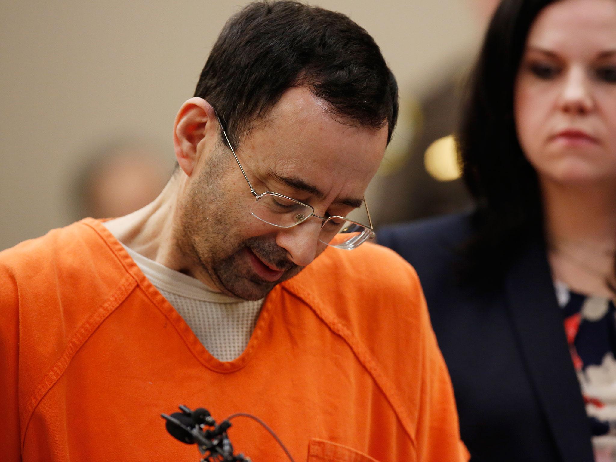 Larry Nassar bowed his head with his eyes closed or looked away as the victims delivered their impact statements