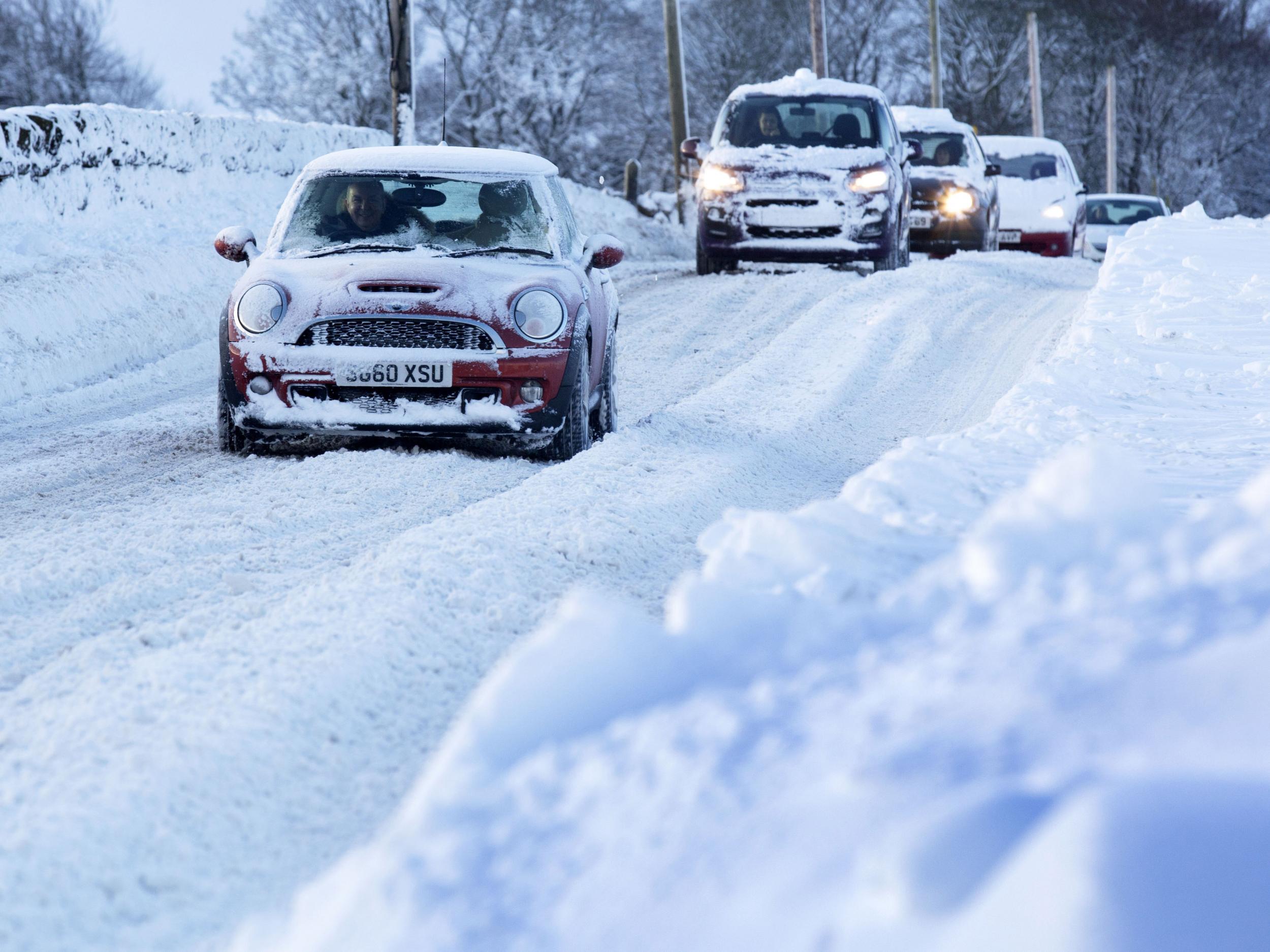 Vehicles make their way through heavy snow in Midlothian near Edinburgh