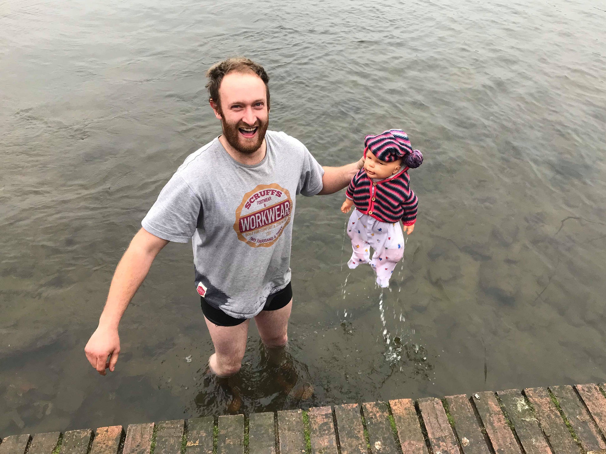 James Dowly, 28, waded through the icy mere to reach the 'baby'