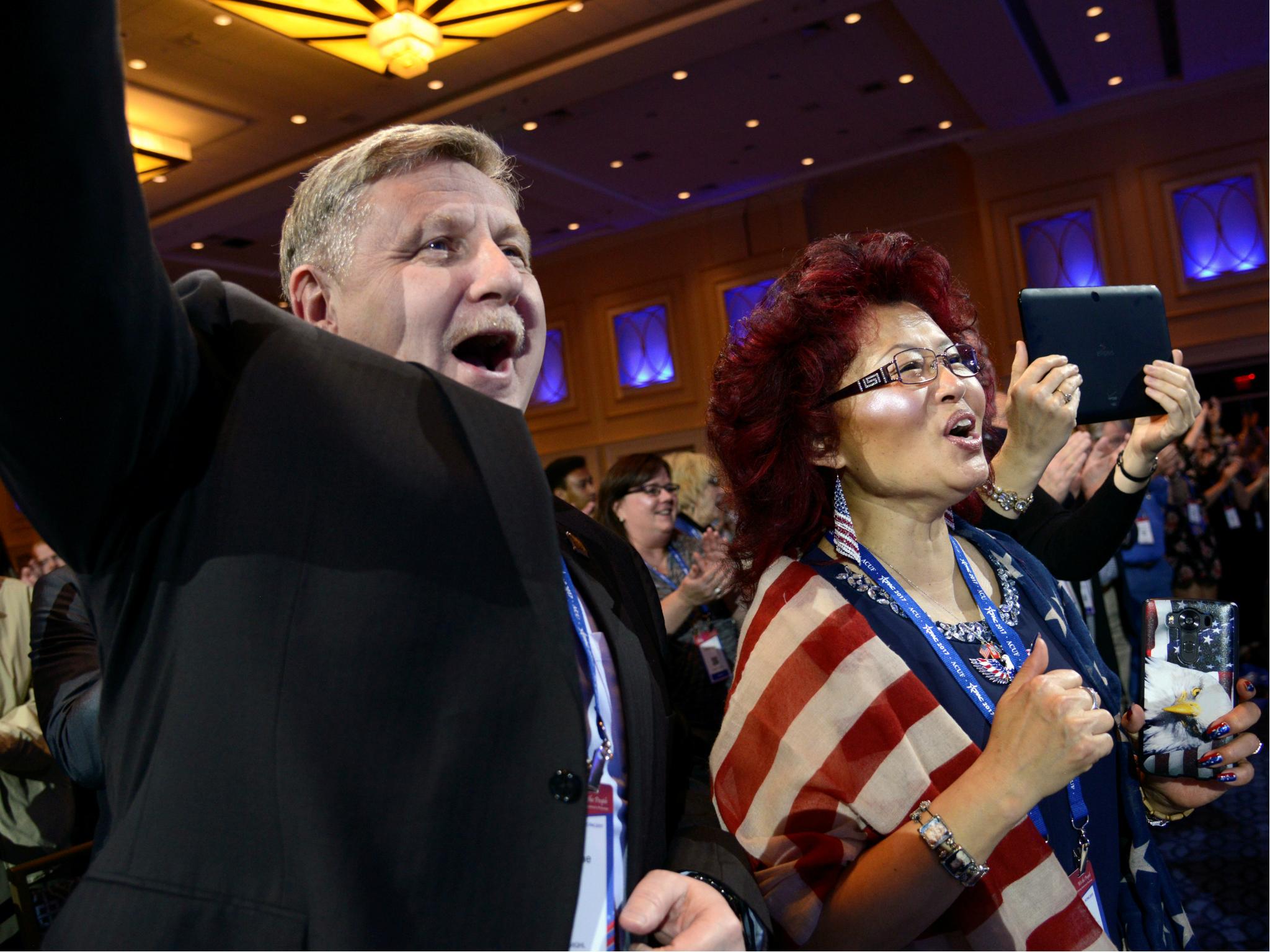 Pennsylvania Congressman Rick Saccone and his wife Yong cheer as they listen to remarks during the Conservative Political Action Conference (CPAC), 22 February 2017.
