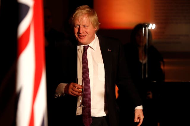 Boris Johnson at an official dinner with Theresa May and Emmanuel Macron
