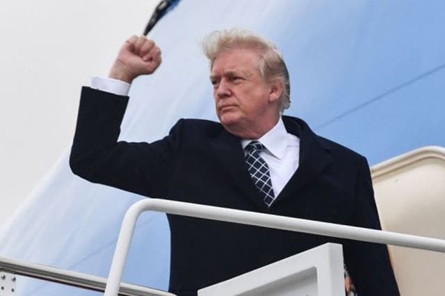 US President Donald Trump gestures as he boards Air Force One at Joint Base Andrews, Maryland on 12 January, 2018, for a weekend trip to Mar-a-Lago