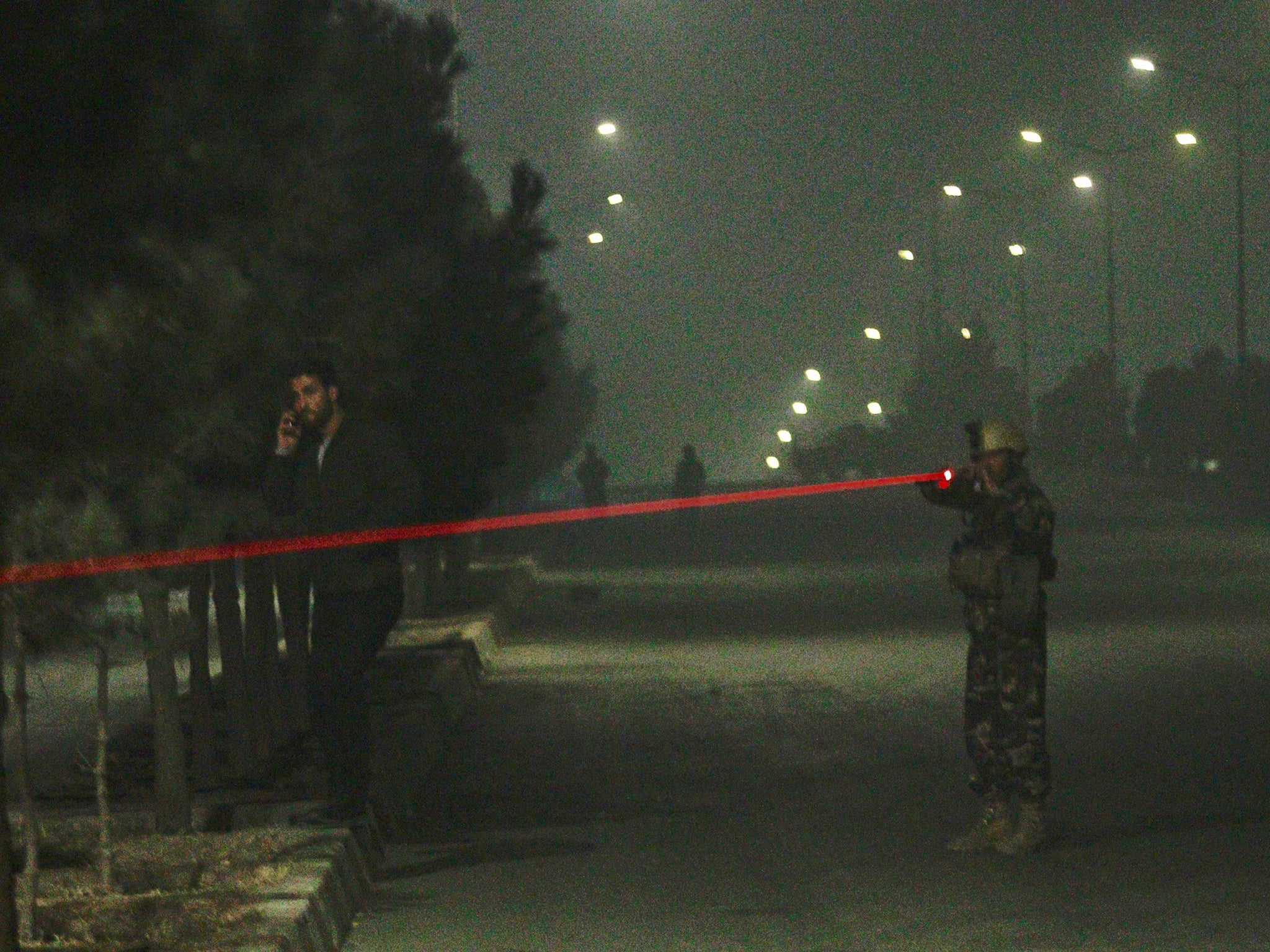 &#13;
Afghan security officials take up positions near the scene of attack by armed men at a hotel in Kabul &#13;