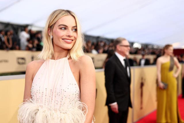 Margot Robbie wore a stunning powder pink Miu Miu gown, a shade which became the unofficial hue of the night