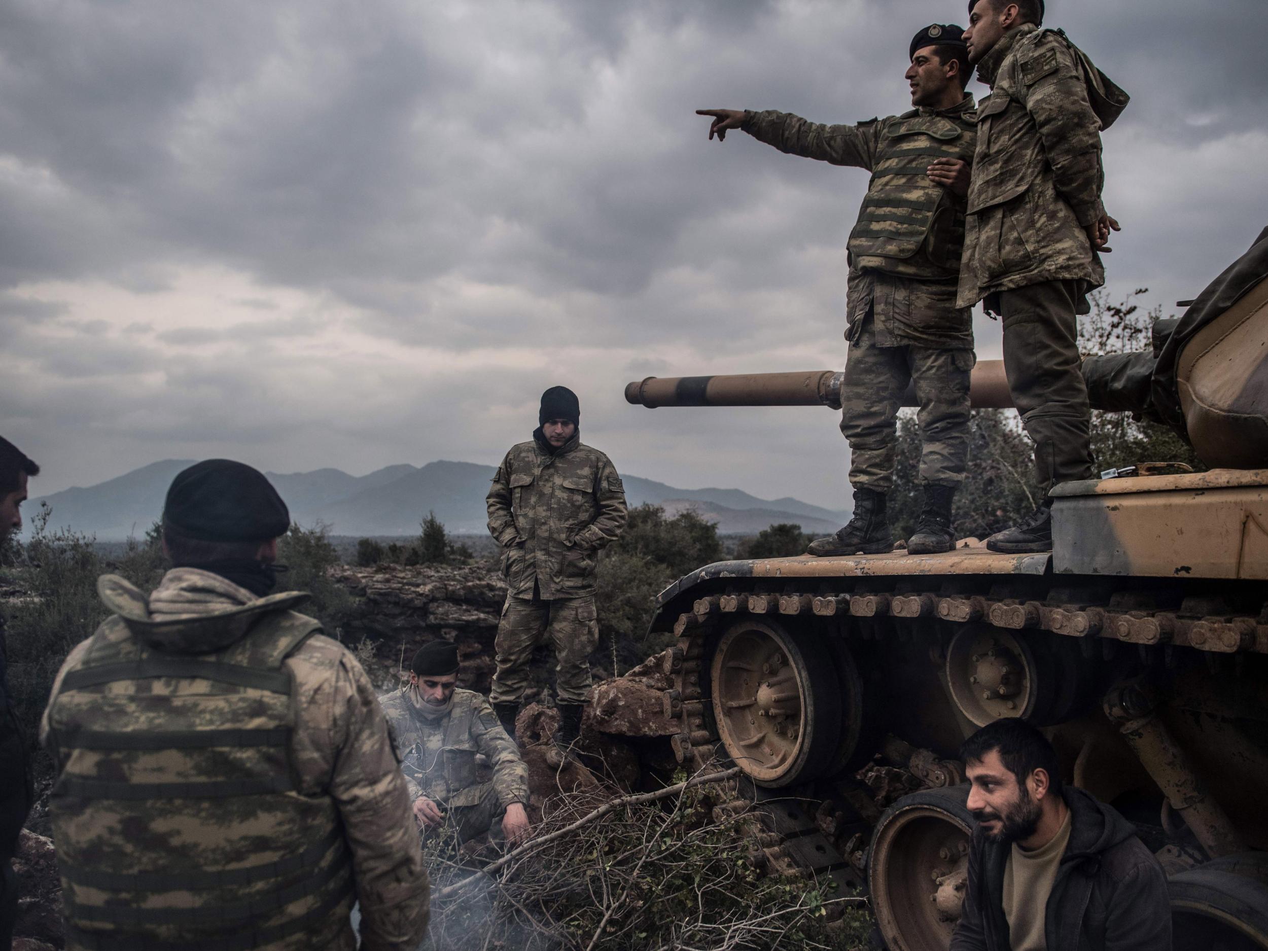 Turkish soldiers wait near the Syrian border at Hassa, in Hatay province on January 21, 2018