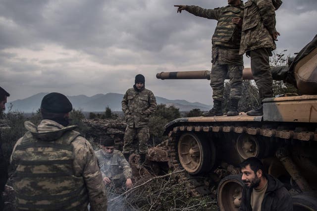 Turkish soldiers wait near the Syrian border at Hassa, in Hatay province on January 21, 2018