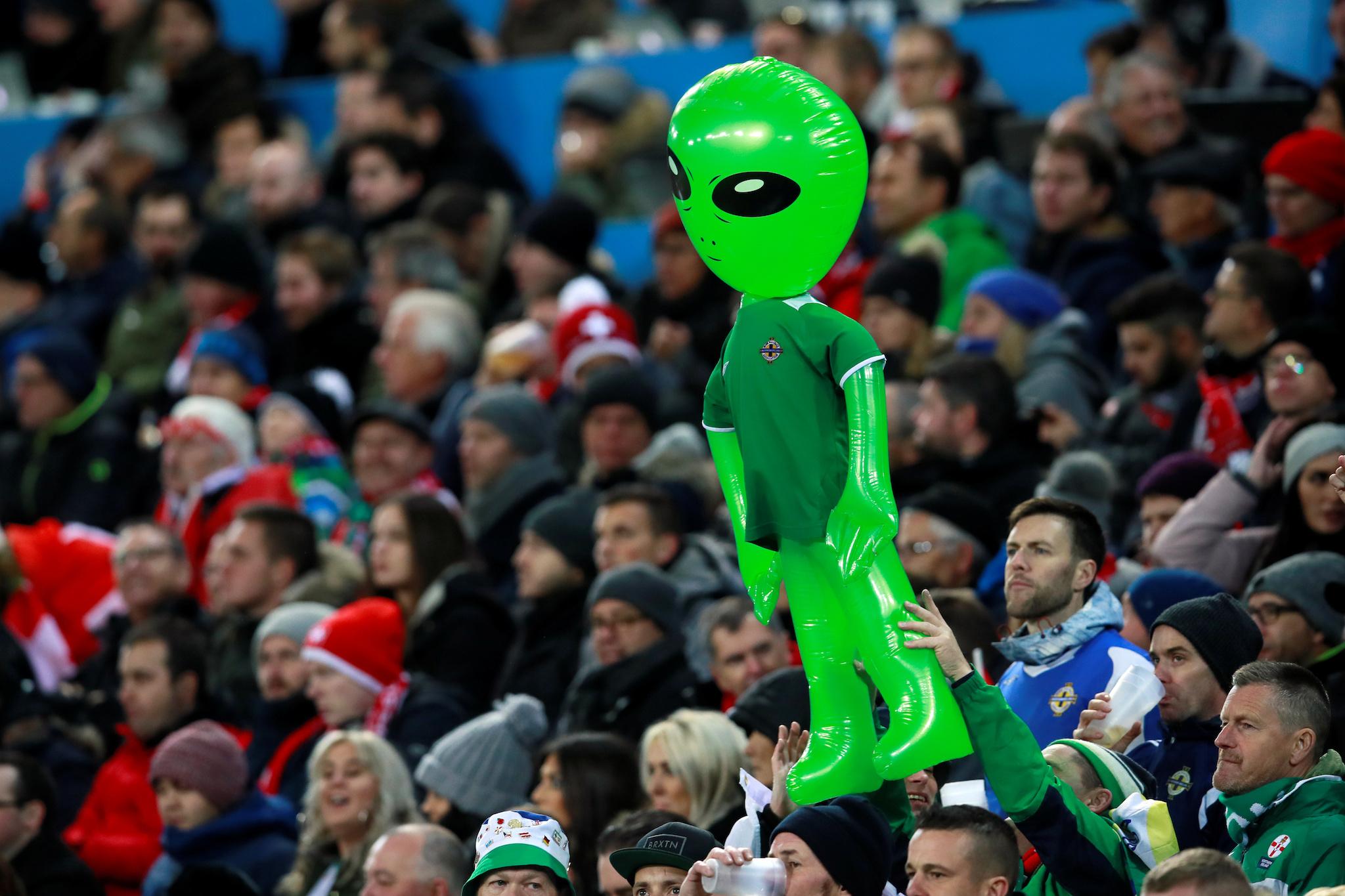 Northern Ireland fans hold up an inflatable alien during a game against Switzerland