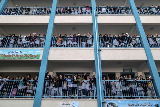 Palestinian schoolgirls pose for a group picture outside their classrooms at a school belonging to the United Nations Relief and Works Agency for Palestine Refugees (UNRWA) in Gaza City on 22 January 2018