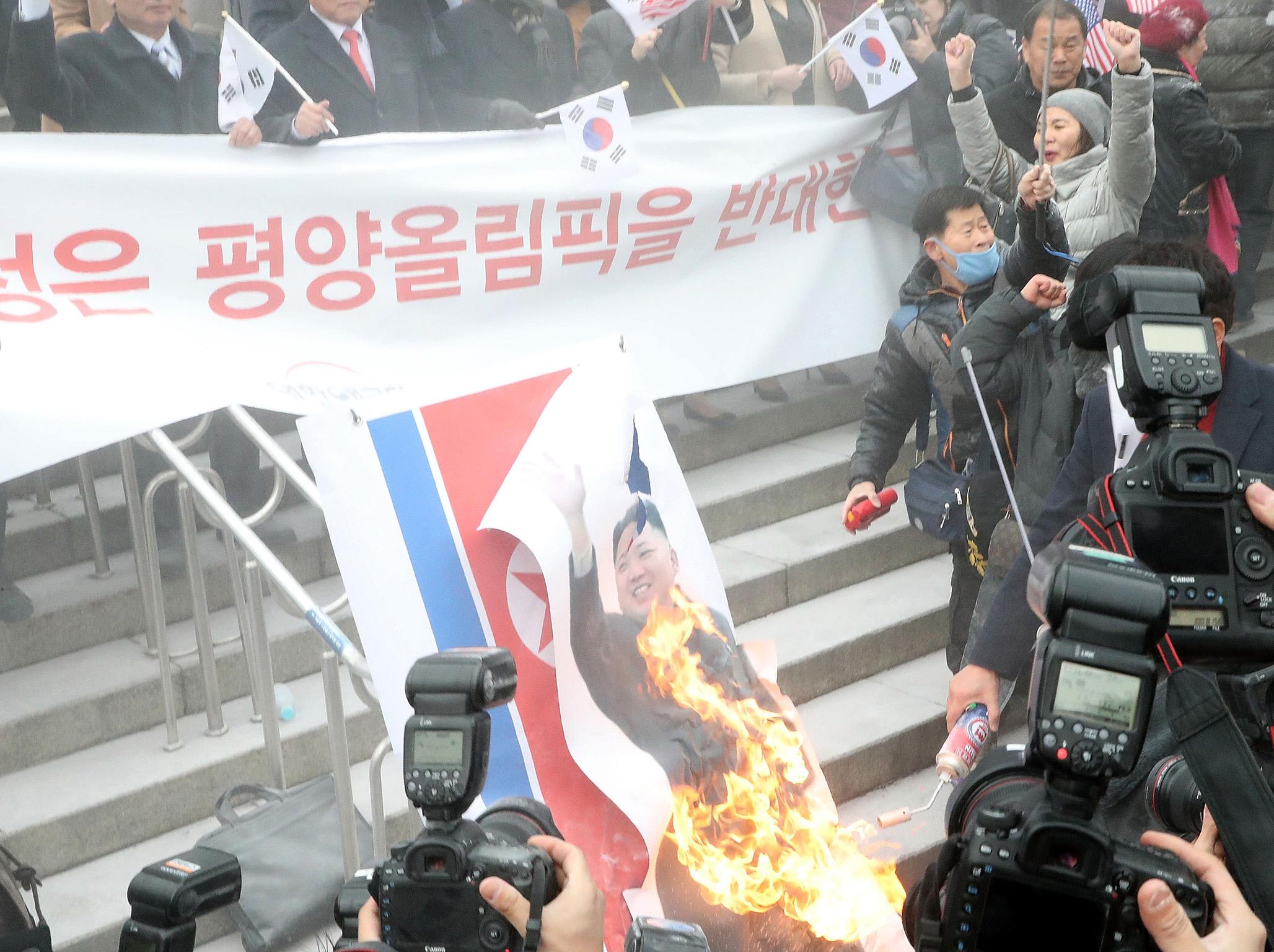 Activists burn a portrait of Kim Jong-Un (Getty Images)