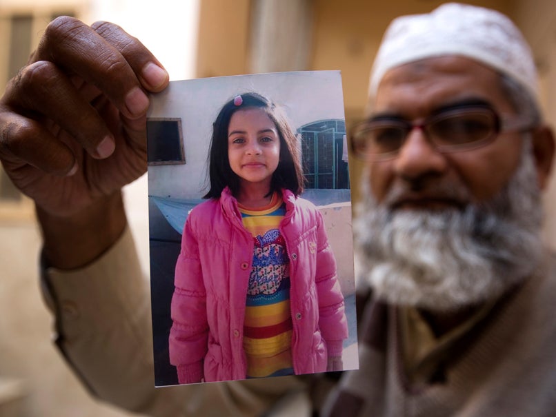 Mohammed Amin shows a picture of his seven-year-old daughter, Zainab Ansari, whose body was left in a rubbish dump last month