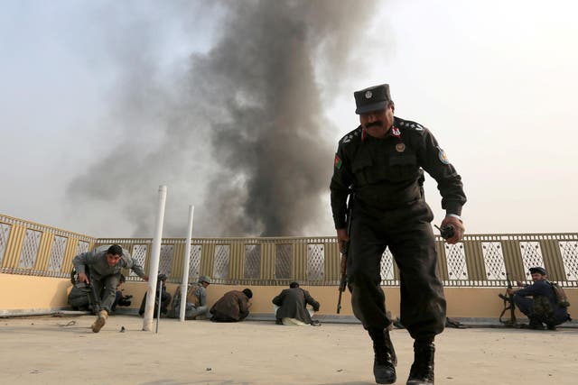 Afghan police officers take position during the fight against Isis militants in Jalalabad