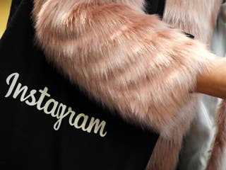 A woman carries an Instagram branded bag at Facebook's headquarters in London, Britain, December 4, 2017