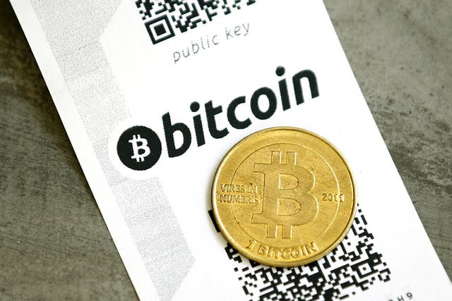 A Bitcoin (virtual currency) paper wallet with QR codes and a coin are seen in an illustration picture taken at La Maison du Bitcoin in Paris, France, May 27, 2015