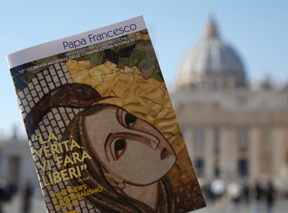 Pope Francis' book on "Fake News", is pictured in front of St. Peter's Basilica, in Rome, 24 January 2018.