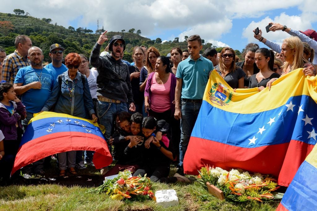 Relatives and friends of two of the six other dissidents gunned down alongside Perez attend their funeral at a cemetery in Caracas on 20 January