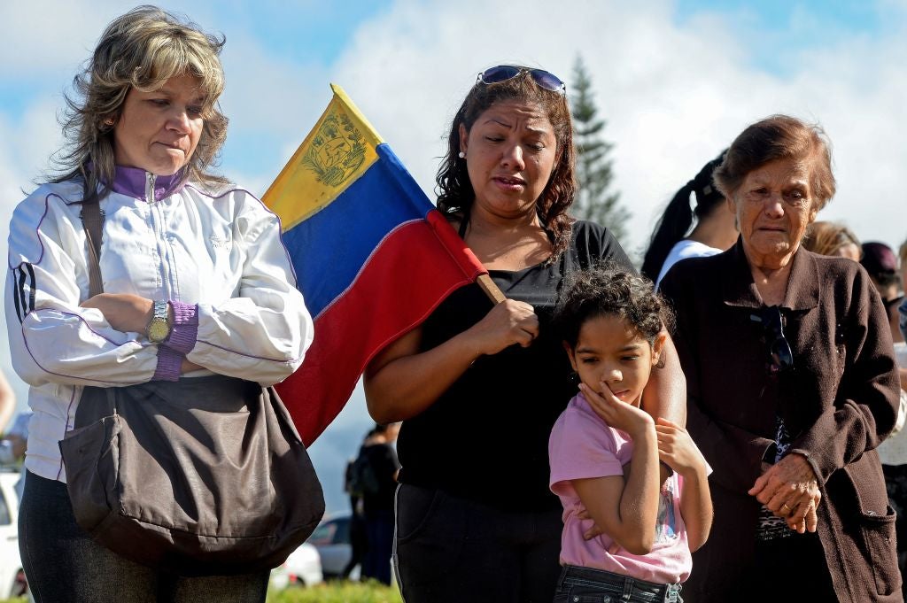 Mourners gather at the graveside of Perez