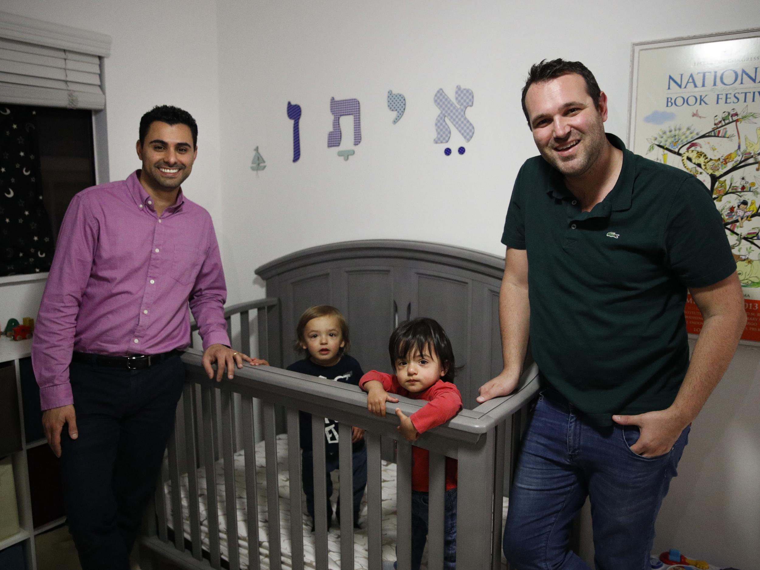 Elad Dvash-Banks, left, and his partner, Andrew, with their twin sons, Ethan, centre right, and Aiden