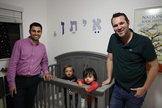 Elad Dvash-Banks, left, and his partner, Andrew, with their twin sons, Ethan, centre right, and Aiden