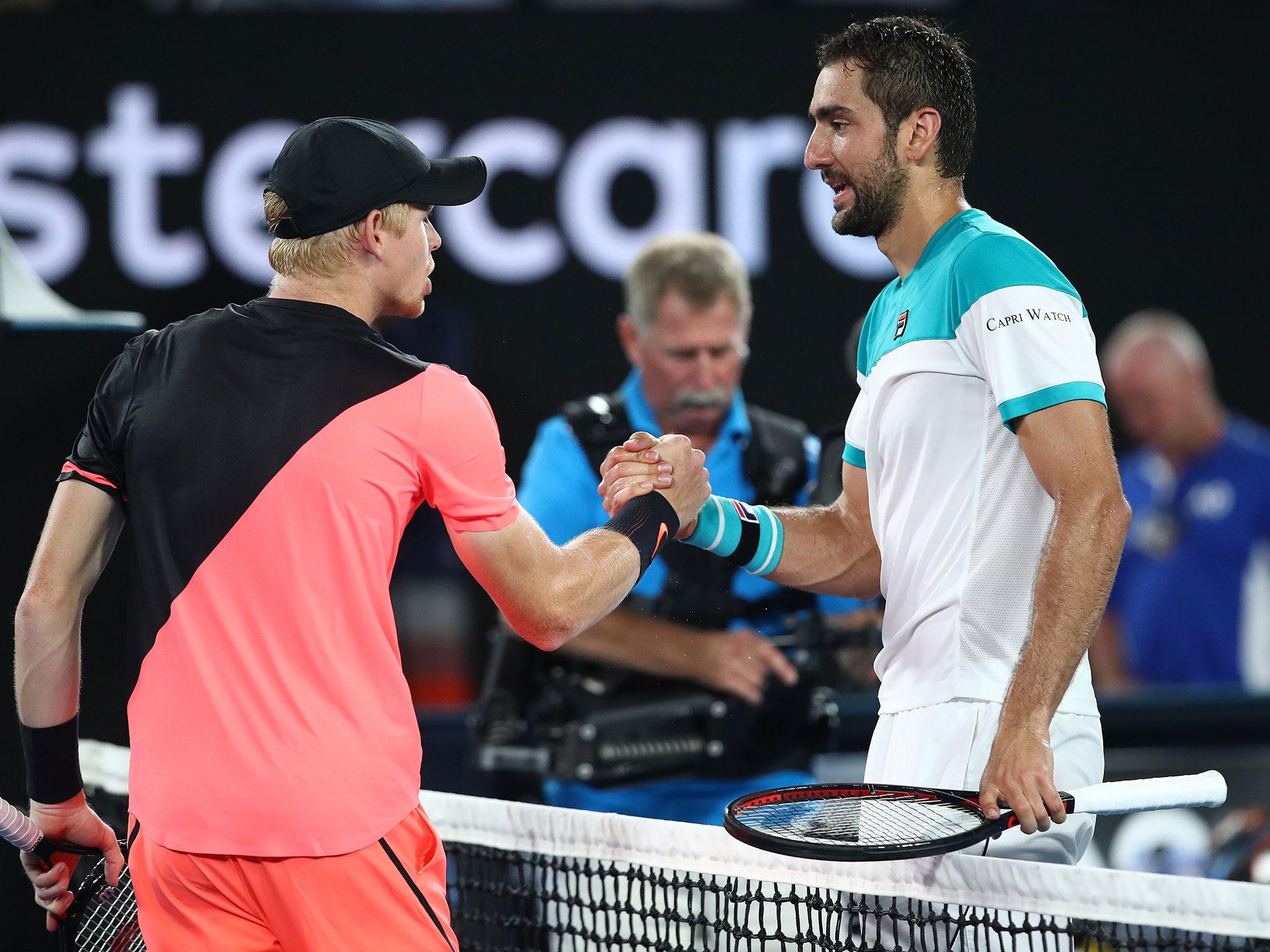 Edmund and Cilic shake hands at the net following the conclusion of their semi-final clash