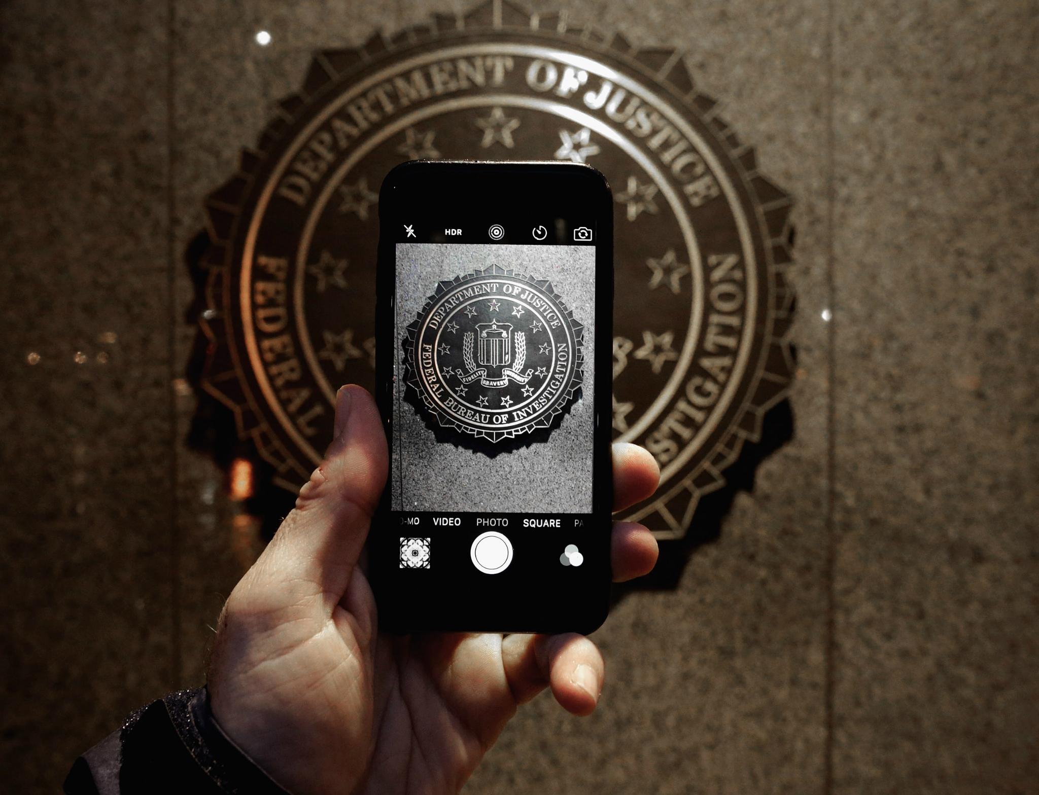 The official seal of the Federal Bureau of Investigation is seen on an iPhone's camera screen