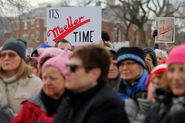Demonstrators hold up signs referencing special counsel Robert Mueller's investigation into the President's ties with Russia during the second annual Women's March in Cambridge, Massachusetts, last weekend