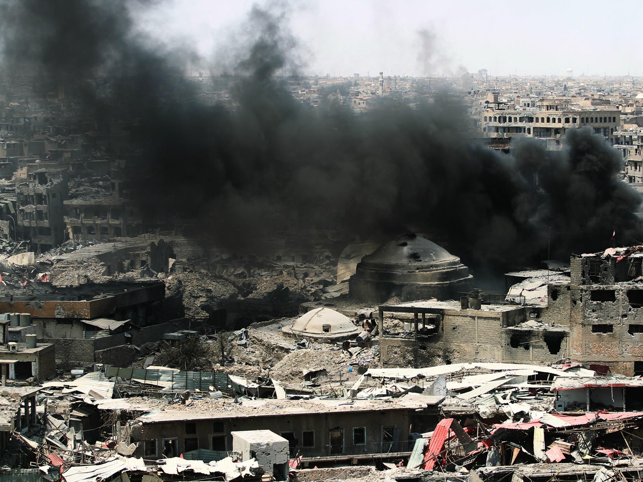 A picture taken on July 9, 2017, shows smoke billowing following an airstrike by US-led international coalition forces targeting Islamic State (IS) group in Mosul, Iraq