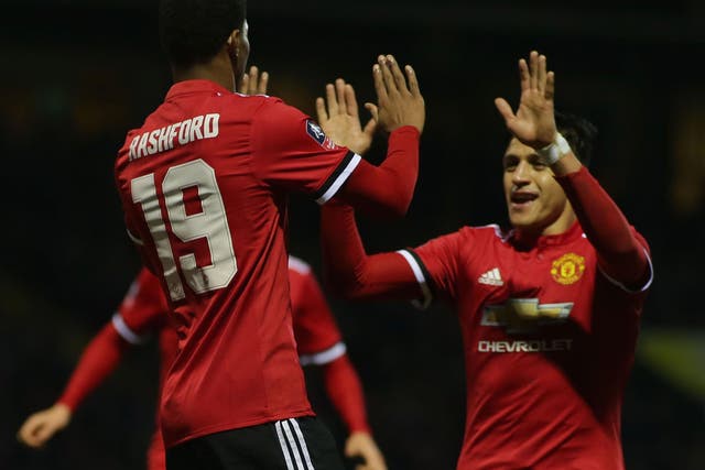 Marcus Rashford celebrates with Alexis Sanchez after putting United ahead