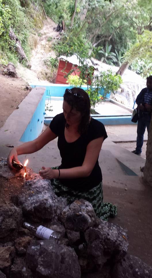 The writer making an offering to Erzulie in Saut-d’Eau