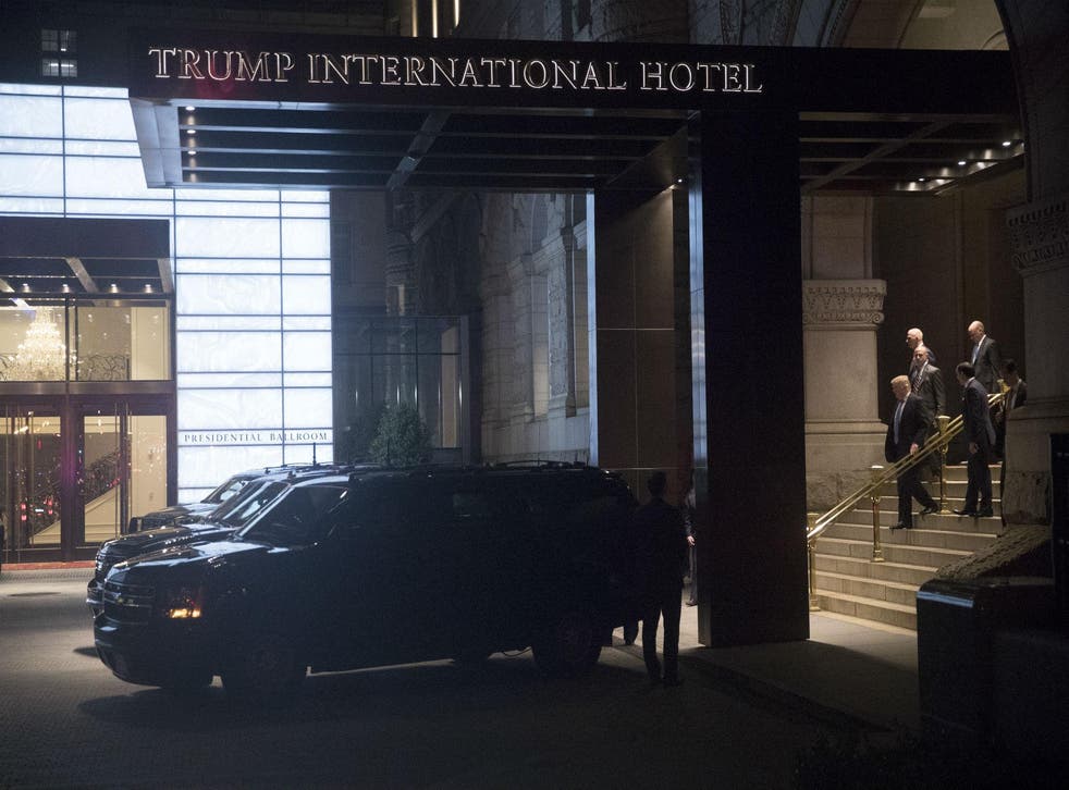 President Donald Trump and first lady Melania Trump walk to the waiting motorcade after having dinner at Trump International Hotel