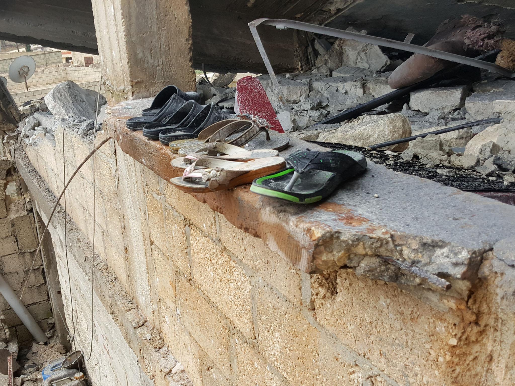 The family’s plastic shoes remain after four members of the al-Khater family died when a Turkish shell hit their home in Maabatli, Kurdish Syria