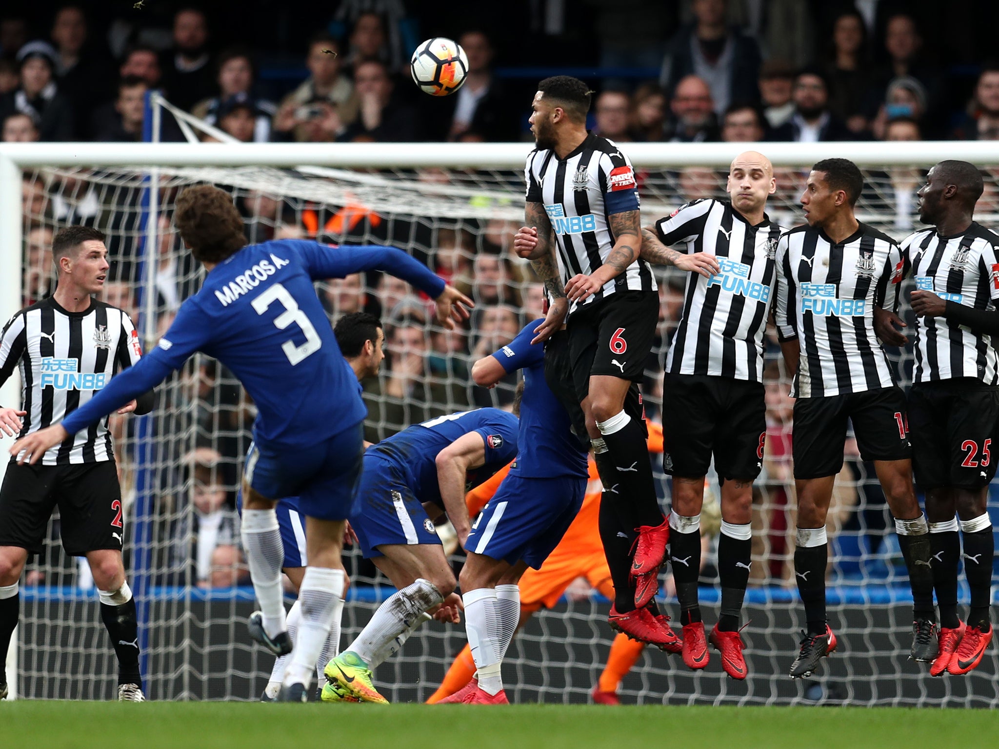Marcos Alonso curls a free-kick into the Newcastle goal to make it 3-0