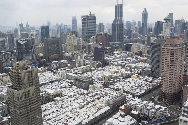 This aerial photograph shows snow on rooftops in Shanghai. China's central and eastern regions have been hit by heavy snowfalls in recent days, causing disruptions to flight and train schedules