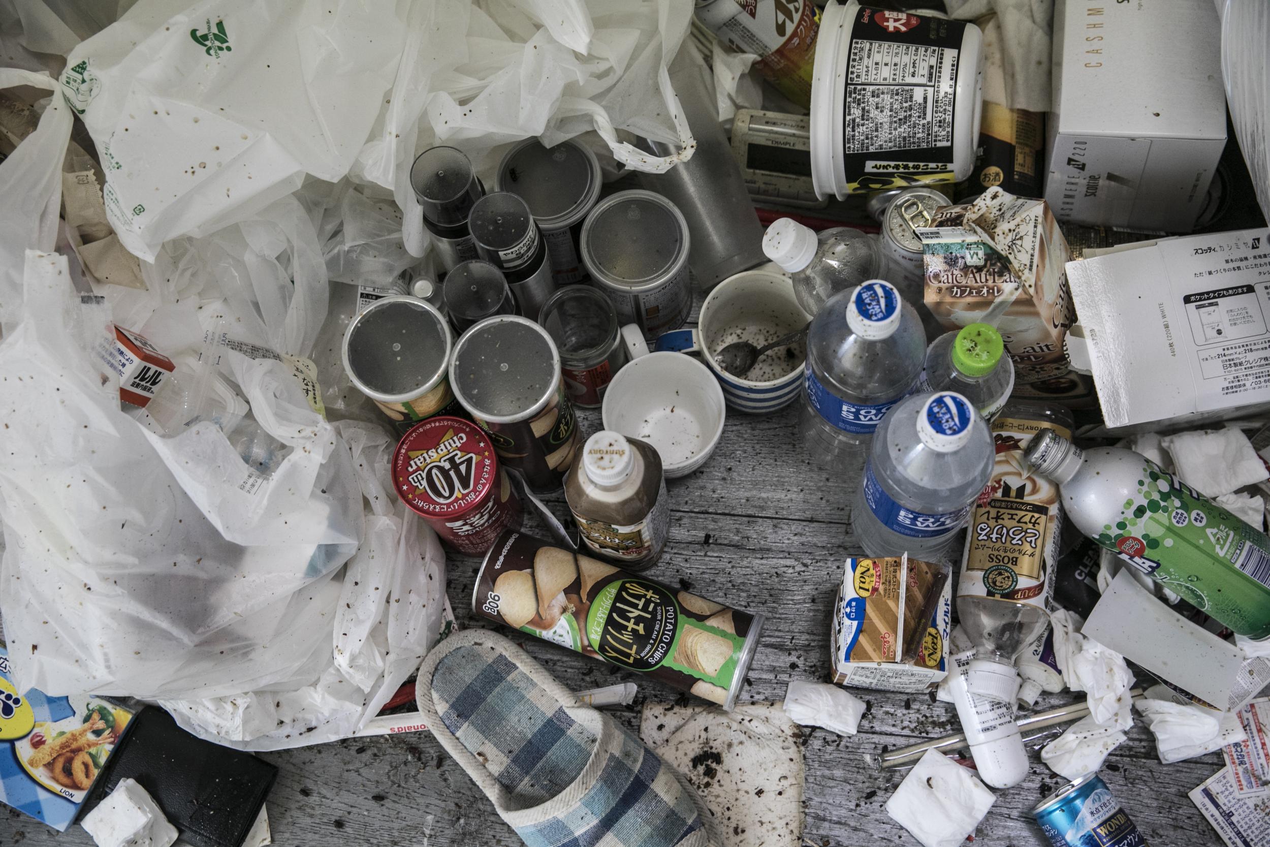 The small flat was full of instant-noodle bowls, soft-drink bottles and empty cans of coffee (Shiho Fukada/Washington Post)