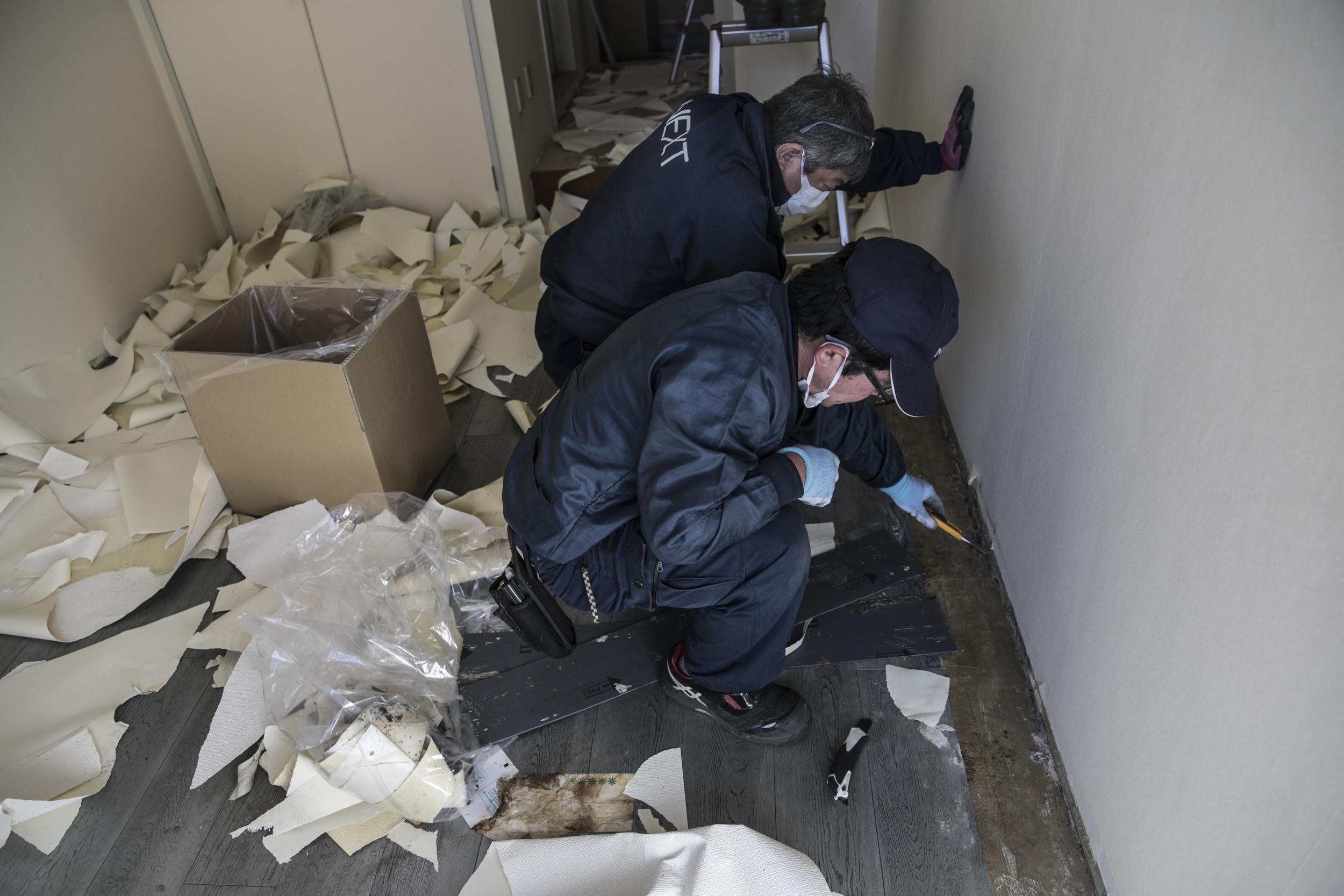 The team from Next examines the floor for bodily fluids (Shiho Fukada/Washington Post)