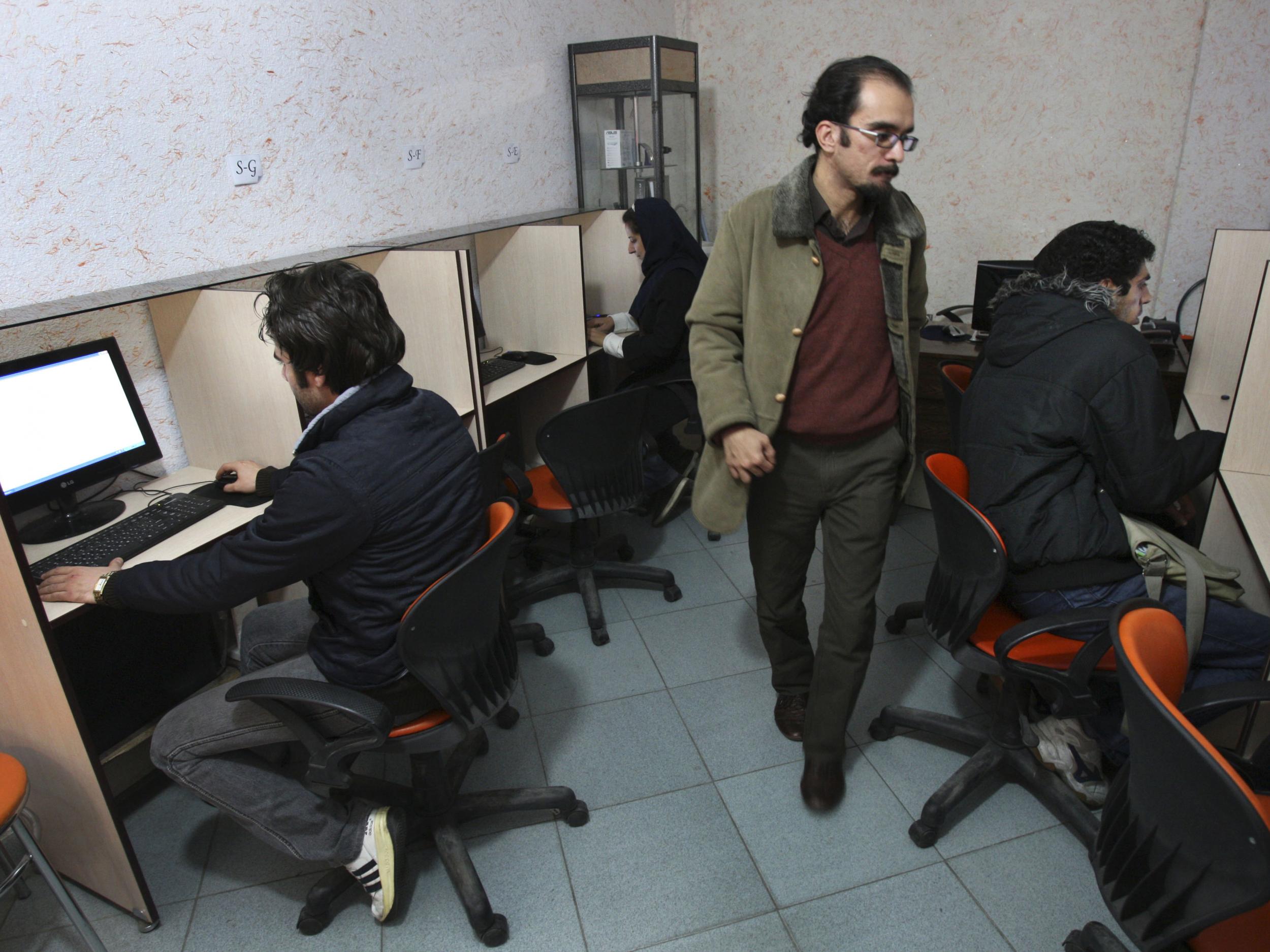Iranians work in an internet cafe in central Tehran