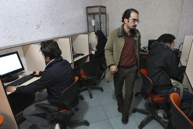 Iranians work in an internet cafe in central Tehran
