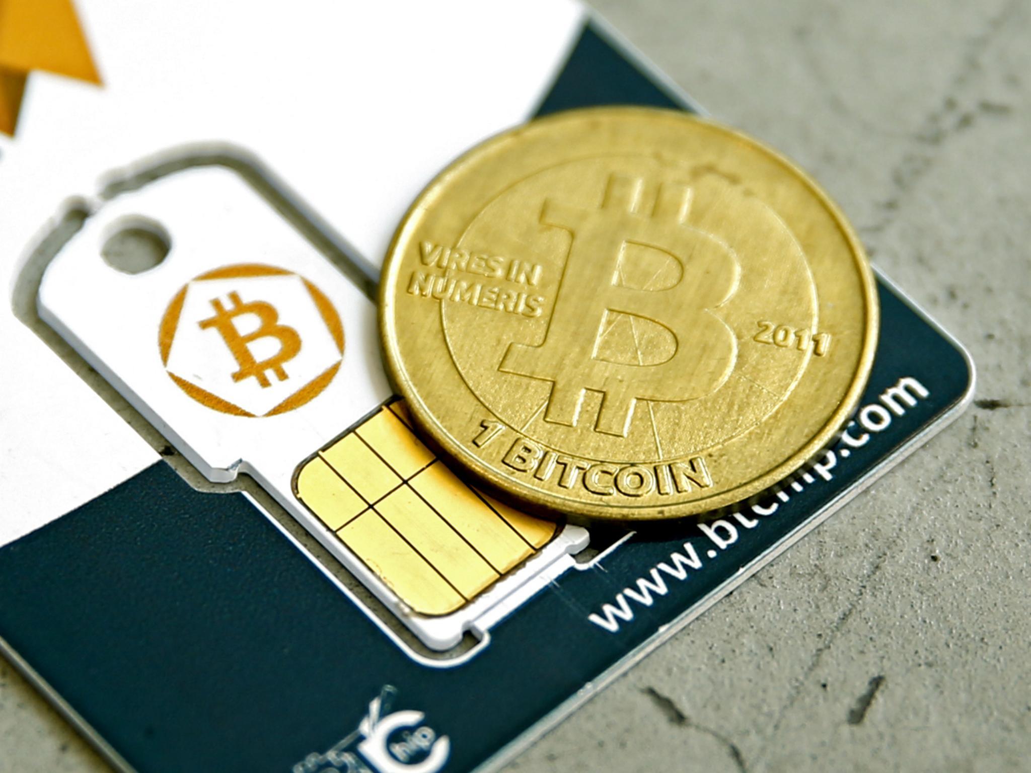 A Bitcoin (virtual currency) hardware wallet and a coin are seen in an illustration picture taken at La Maison du Bitcoin in Paris, France, May 27, 2015