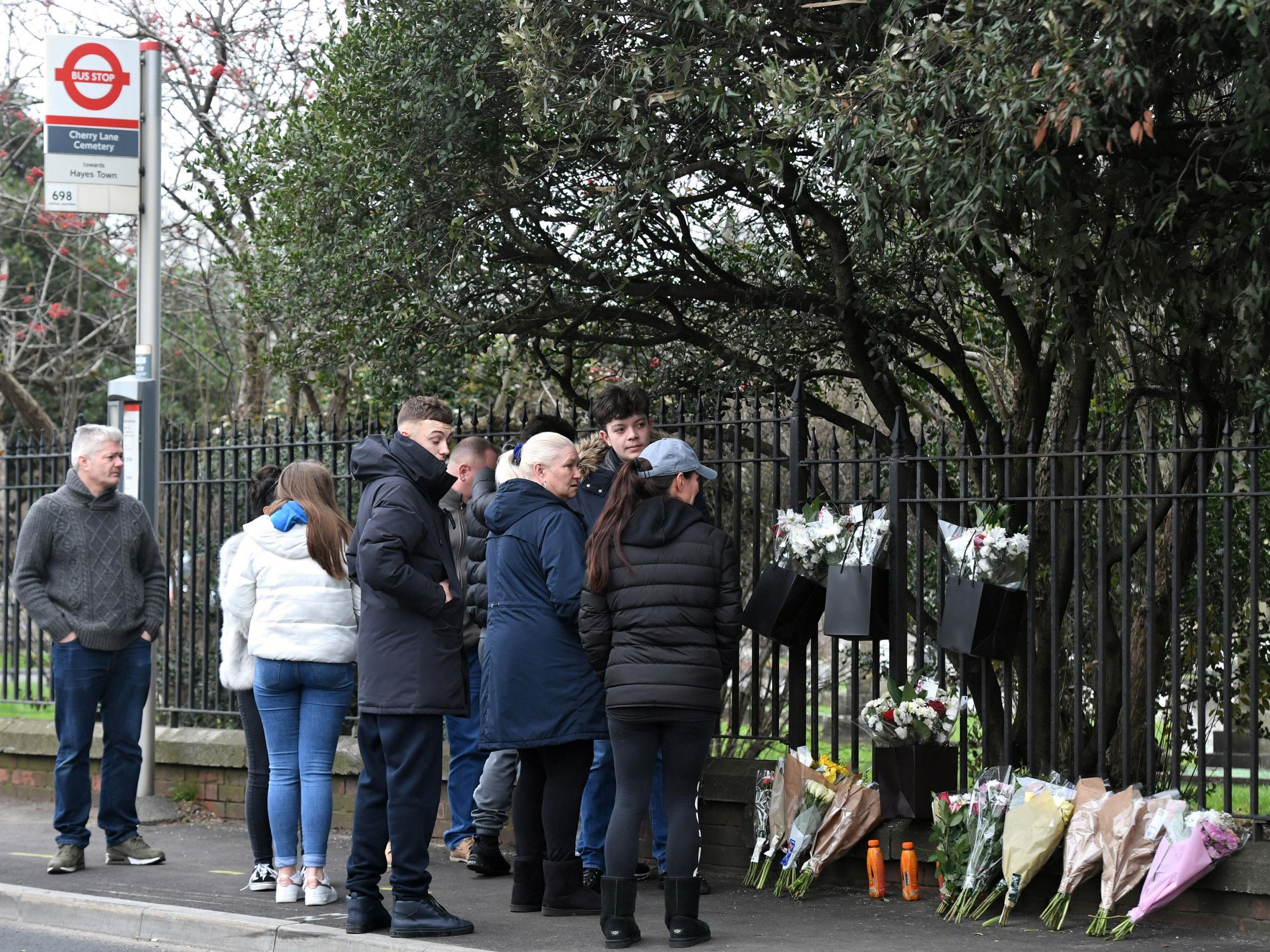 People at the scene in Shepiston Lane in Hayes where three teenage boys have died after a car ploughed into a bus stop