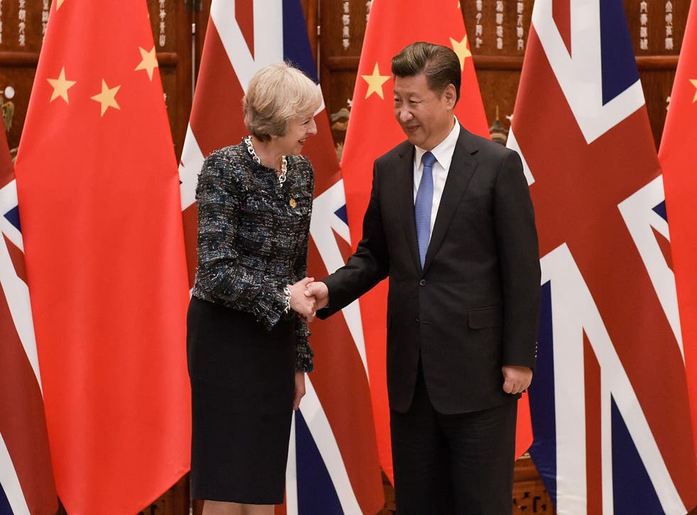 Chinese President Xi Jinping shakes hand with Theresa May at their meeting in 2016